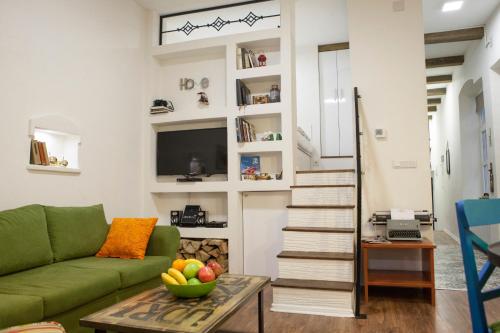 a living room with a green couch and a table at Apartment Milk&Honey - free Parking in Sarajevo