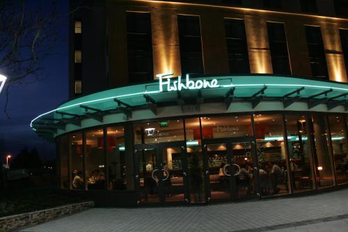 aidium sign on the front of a building at night at Future Inn Plymouth in Plymouth