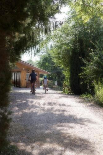 two people riding bikes down a dirt road at Etangs du Moulin in Suzy