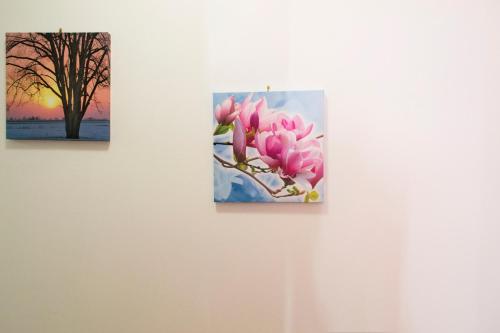 two paintings of a pink flower on a wall at City center apartment in Umag