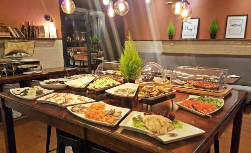 a buffet with many plates of food on a table at Hotel Hanza in Gdańsk