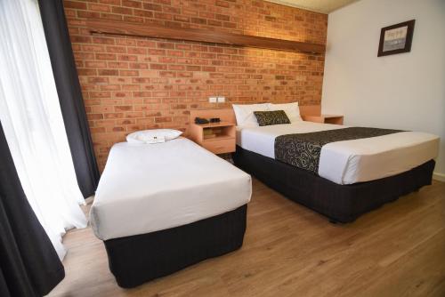 Säng eller sängar i ett rum på Dandenong Motel