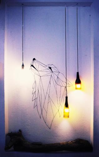 two lights and a umbrella hanging from a wall at Samstay in Tuy Hoa