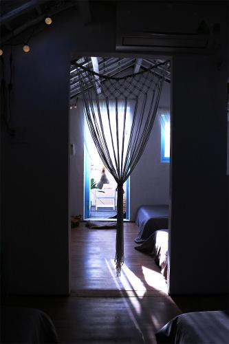 a room with two beds and a window with curtains at Samstay in Tuy Hoa