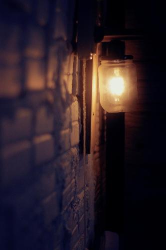 a light on the side of a brick wall at Samstay in Tuy Hoa