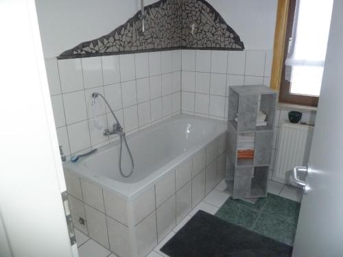 a bath tub in a bathroom with a shower at im gelben Haus in Trusen