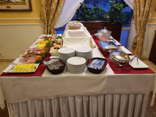 a table with a buffet of food on it at Hotel Pikul in Puławy