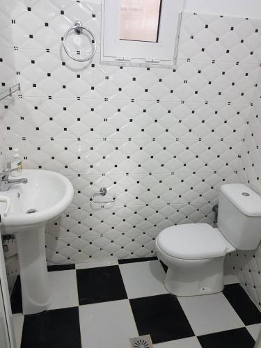 a bathroom with a white toilet and a sink at Villa Nicolaos Ksamil in Ksamil