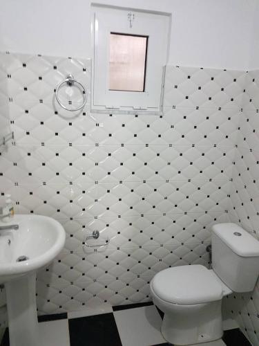a bathroom with a white toilet and a sink at Villa Nicolaos Ksamil in Ksamil