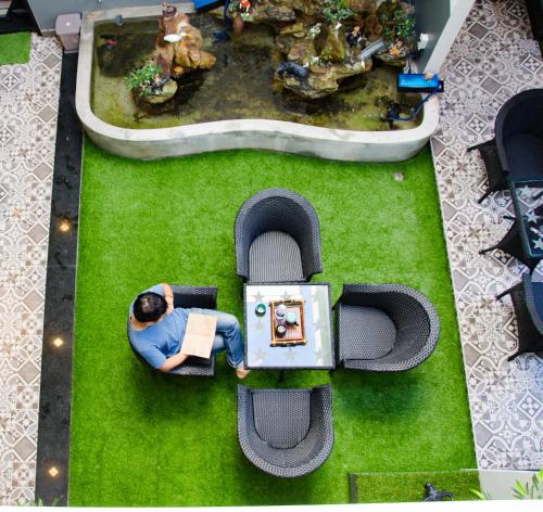 an overhead view of a man in a toy car in a park at La Me Villa Hoi An in Hoi An