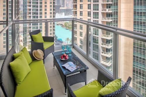 a balcony with a table and chairs and a view of a city at Dream Inn Apartments - Burj Residences Burj Khalifa View in Dubai