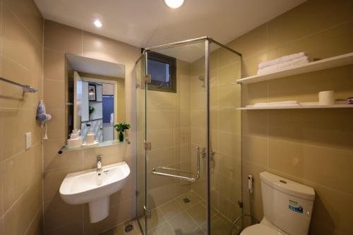a bathroom with a shower and a toilet and a sink at MRT Apartment In Masteri Thao Dien in Ho Chi Minh City