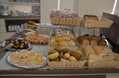 a buffet with many different types of bread and pastries at Hotel Victoria in Vicenza