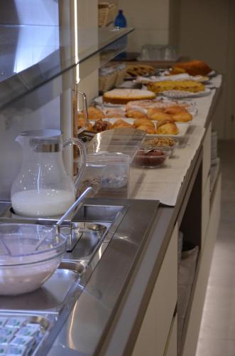 a buffet line with a bunch of pastries on at Hotel Victoria in Vicenza