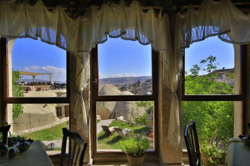 a window with a view of a mountain view at Traveller's Cave Hotel in Goreme