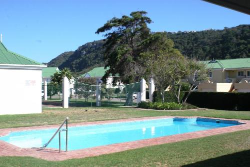 a swimming pool in the yard of a house at Riverclub Villas in Plettenberg Bay