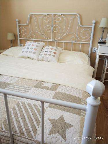 a bed with a metal frame and pillows on it at Penzion Flipper in Revúca