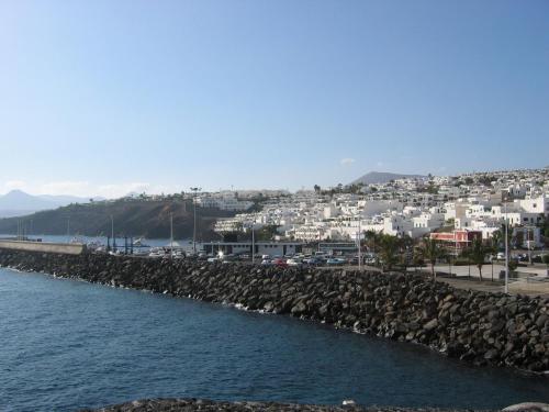 a view of a city from the shore of the water at Hostal Magec in Puerto del Carmen