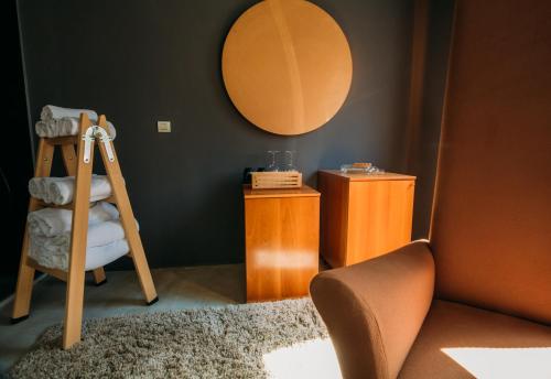 a room with a ladder and a mirror and a chair at Boutique Hotel Valsabbion in Pula