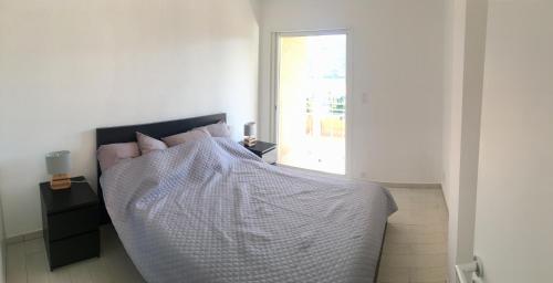 a bedroom with a large bed with a window at I Tre Sirenelli in Propriano