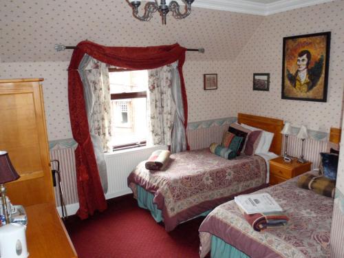 a bedroom with two beds and a window at Ferintosh Guest House in Dumfries