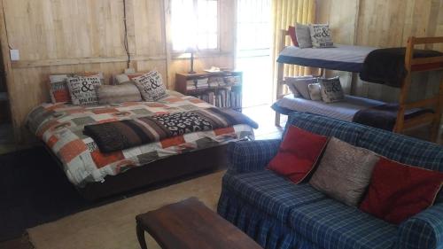 a bedroom with a bed and a couch at Isikhoma-Khoma in Hilton