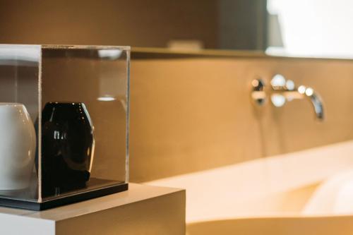 a bathroom counter with a soap dispenser and a sink at Boutique Hotel Valsabbion in Pula