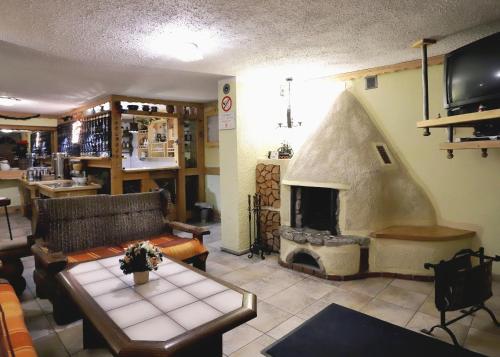 a living room with a couch and a fireplace at Pensjonat Tara in Jeleśnia