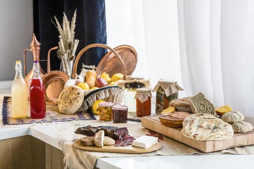 a table topped with lots of bread and other foods at Tarcin Forest Resort & Spa Sarajevo - MGallery Collection in Tarčin