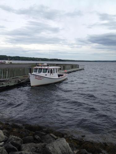 a boat is docked at a dock on the water at Braeside Country Inn in Pictou