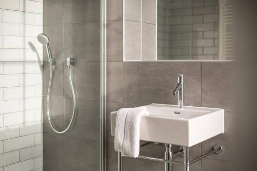 a bathroom with a sink and a shower at JOIVY Spacious Apartment close to Princes Street in Edinburgh