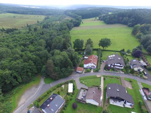 an aerial view of a village with houses and a road at Solling-Lounge in Holzminden