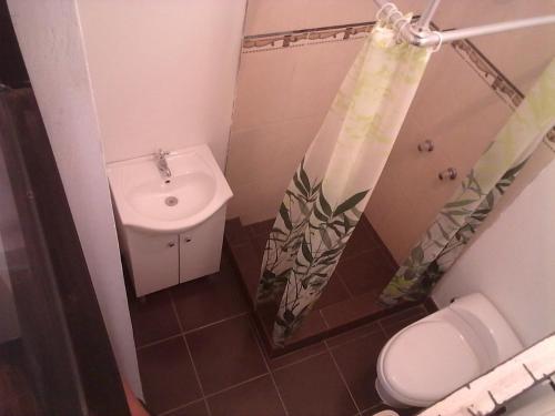 a small bathroom with a sink and a toilet at La Maison de Lydia in Nazca
