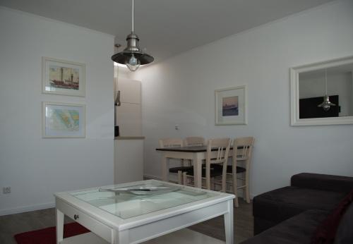 a living room with a coffee table and a dining room at Hotel Stadt Cuxhaven in Cuxhaven