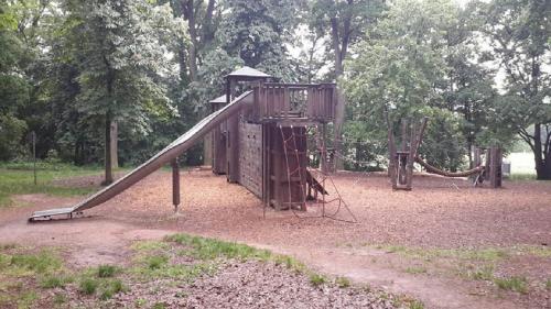 a playground with a slide in a park at Parkhotel Zirndorf in Zirndorf