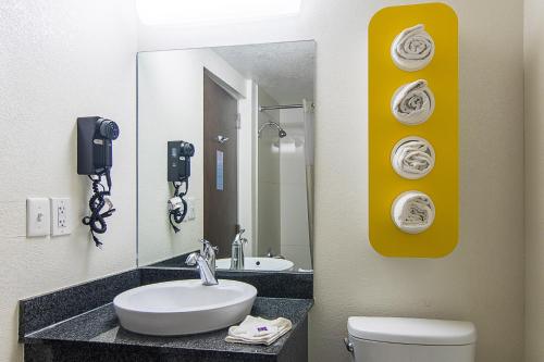 a bathroom with a sink, toilet and mirror at Motel 6-Atlanta, GA - Virginia Ave in Atlanta