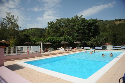 a large swimming pool with people in the water at La Bohème in Tournon-sur-Rhône