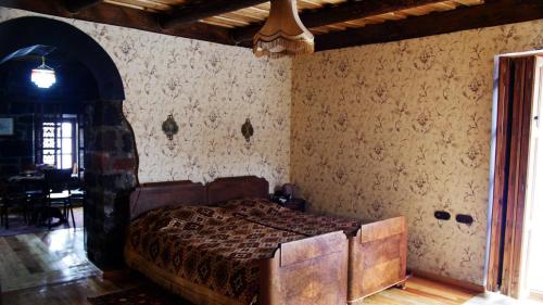 a bedroom with a bed in a room at Hye Aspet Հայ Ասպետ in Gyumri