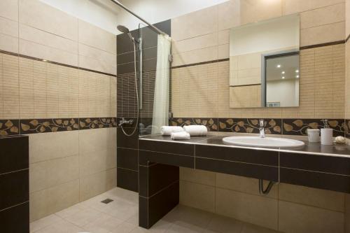 a bathroom with a sink and a mirror at Apartment at Koukaki, 150m from the metro by YHA in Athens