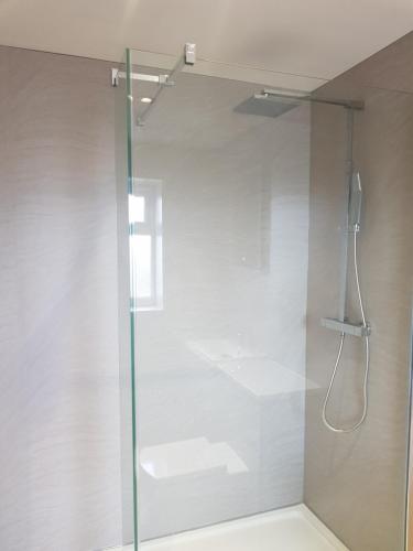 a bathroom with a shower with a glass door at The Studio in Ingoldmells