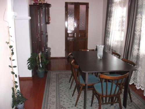 a dining room with a black table and chairs at Apartment Giorgi in Sighnaghi in Sighnaghi
