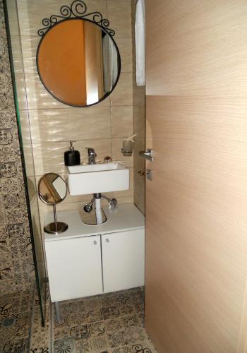 a bathroom with a sink and a mirror at Villa Ekali in Limenaria