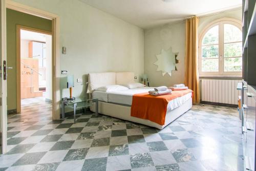 a bedroom with a bed and a checkered floor at Luxury Villa with pool in Pietrasanta