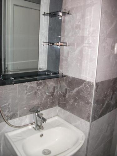 a bathroom with a sink and a mirror at Apartment Giorgi in Sighnaghi in Sighnaghi