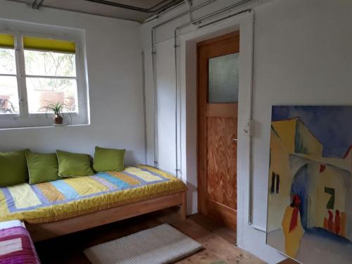 a room with a couch and a window and a door at B&B am Park in Rheinfelden