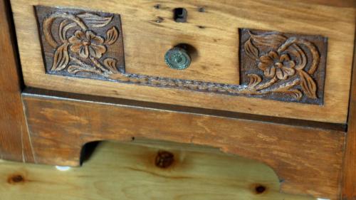 a wooden box with a drawer with flowers on it at Hye Aspet Հայ Ասպետ in Gyumri