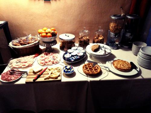a table with a bunch of different types of food at Albergo San Lorenzo in Alba