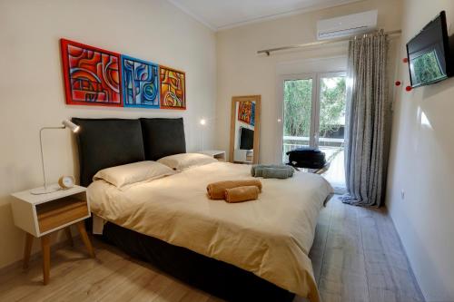 a bedroom with a large bed and a window at Phaedrus Living City Center Luxury Flat Kolonaki in Athens