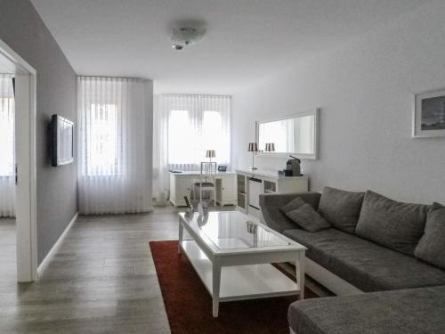 a living room with a couch and a coffee table at Hotel Stadt Cuxhaven in Cuxhaven