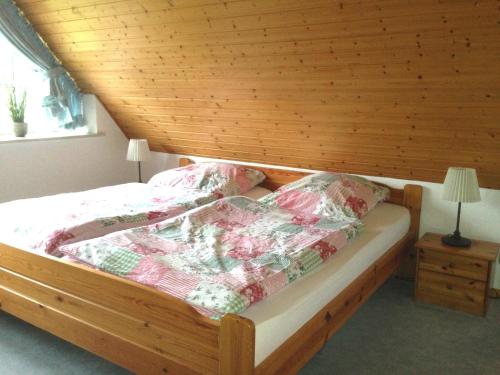 a bedroom with a bed with a wooden ceiling at Landhaus von Frieling in Soltau